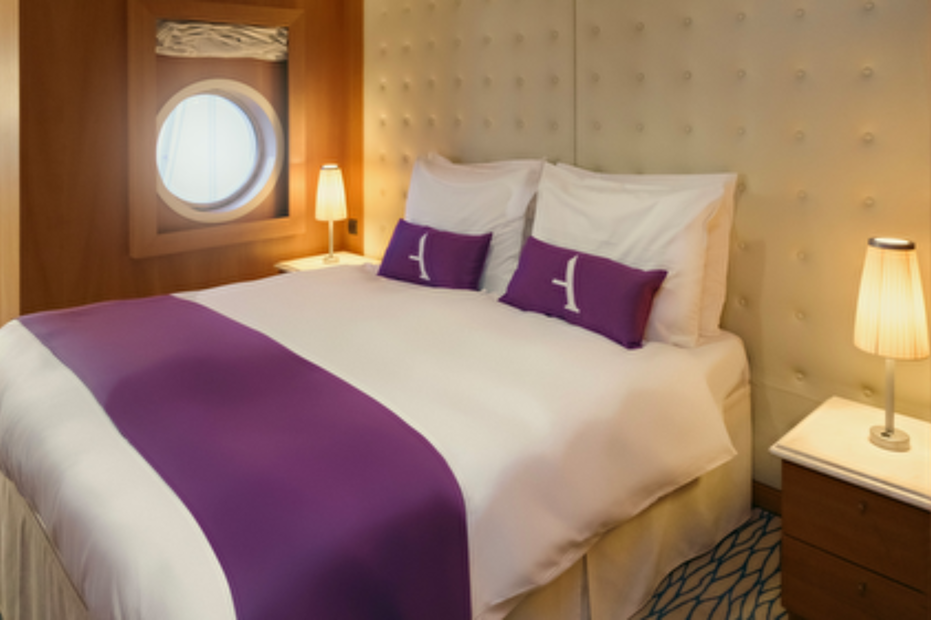 A cabin with king size bed aboard Ambassador Ambition