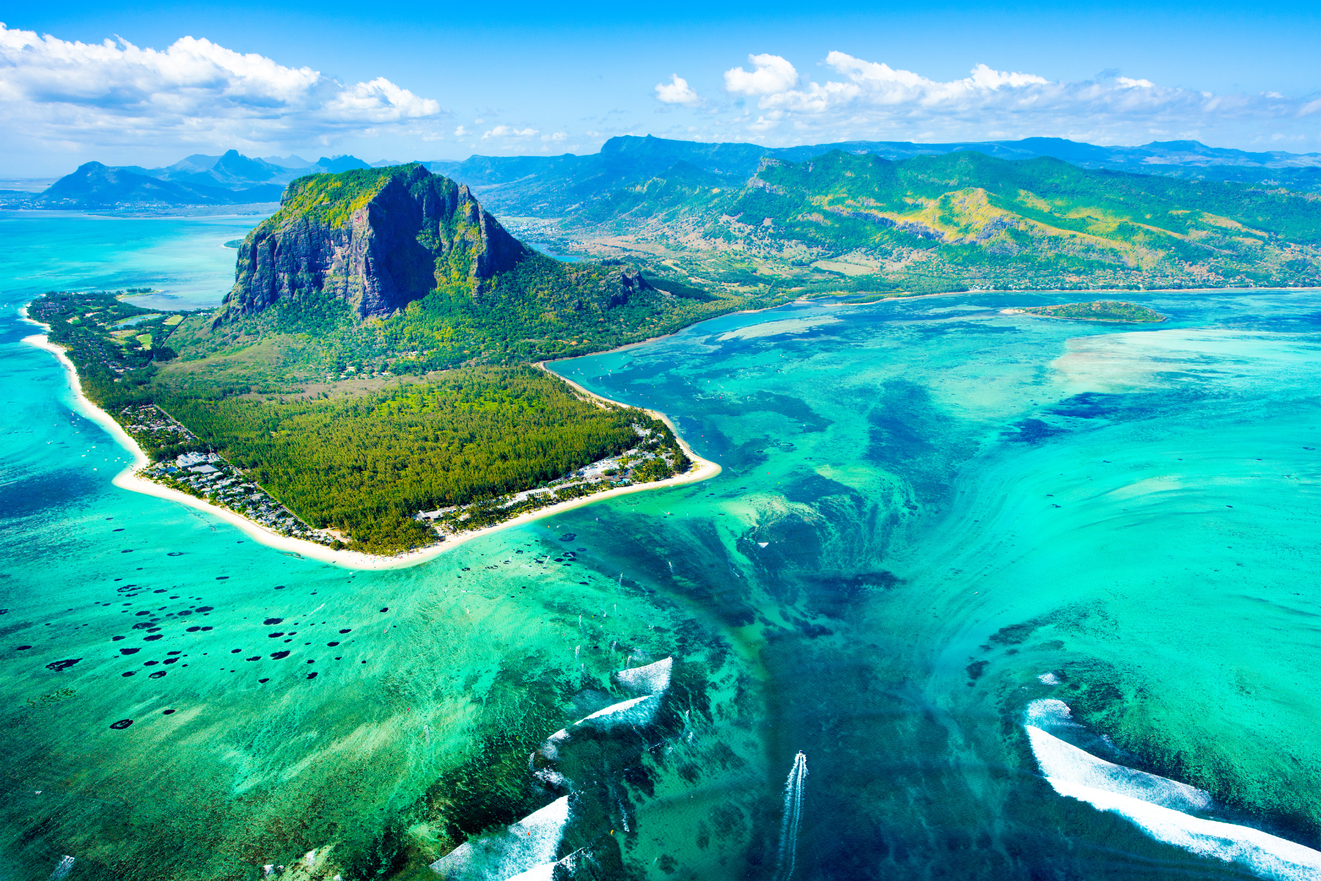 A Mauritius scenic image with mountains and aqua coloured sea