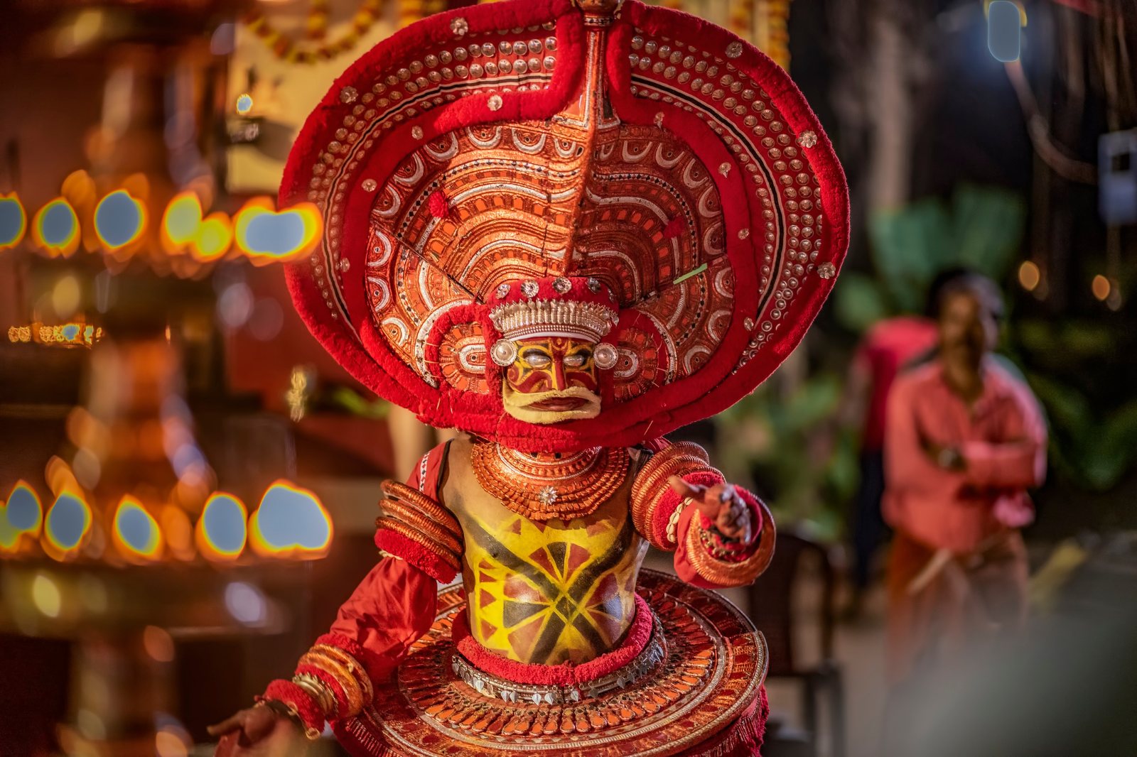 indian man performing theyyam ritual form of dance