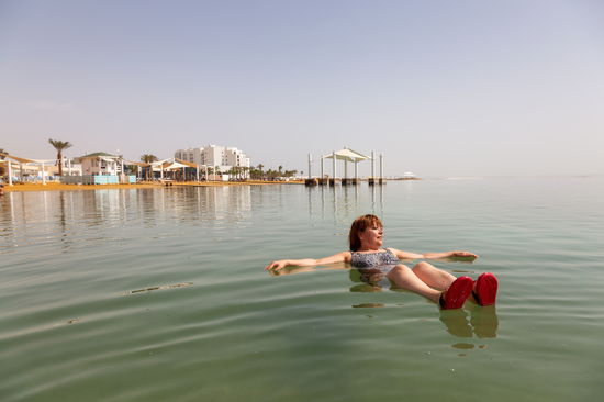 Woman floats in Dead Sea in Jordan
