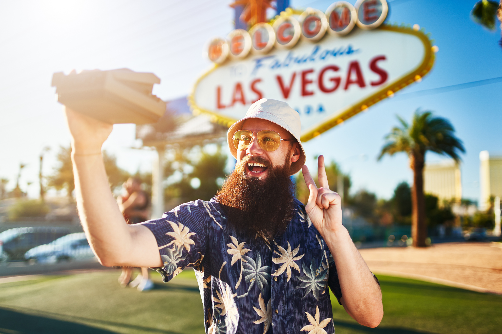 A tourist poses by the Las Vegas sign